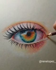 someone is drawing an eye with colored pencils