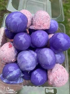 purple and pink candy balls in a plastic container