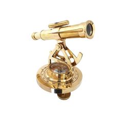 a golden compass on top of a white surface with a telescope in the center and an eyepiece to look at