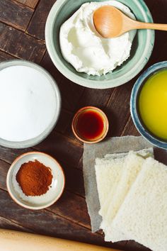 ingredients for making cake sitting in bowls on a wooden table