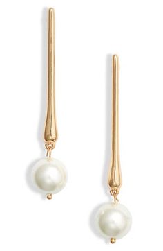 Liquid bar drops suspend lustrous faux pearls on elegantly tapered earrings finished in high-shine goldtone plate. 2 1/2" drop Surgical steel post back Goldtone plate/glass faux pearl Imported Modern Bridal Earrings, Gold And Pearl Earrings, Gold Bead Earrings, Justin Alexander, Gold Pearl Earrings, Steel Post, Modern Bridal, Gold Drop Earrings, Pearl Drop Earrings