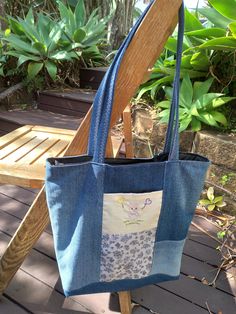 Tote bag made from reclaimed denim and fabric remnants features an embroidered picture and an internal pocket featuring the same character as the front, has three pockets  all together. measurements 33cm hight 30cm wide 9cm side Denim Blue Cotton Shoulder Bag With Zipper Pocket, Denim Blue Cotton Shoulder Bag With Double Handle, Denim Blue Cotton Bag With Zipper Pocket, Denim Blue Cotton Tote Shoulder Bag, Blue Recycled Denim Bag With Zipper Pocket, Blue Cotton Bags With Zipper Pocket, Blue Cotton Bag With Zipper Pocket, Casual Cotton Patchwork Bag, Recycled Denim Tote Shoulder Bag With Pockets