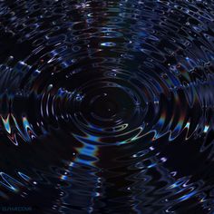 an abstract image of water ripples in blue and black colors, with the light reflecting off