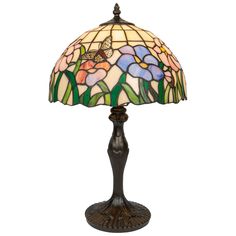 a table lamp with a butterfly on it's arm and flowers in the shade