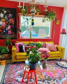 a living room filled with lots of colorful furniture and flowers in vases on the table