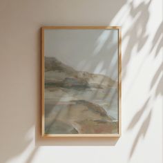 a painting hanging on the wall next to a plant