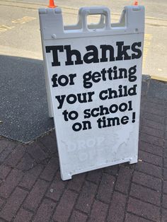 a sign on the sidewalk that says thanks for getting your child to school on time