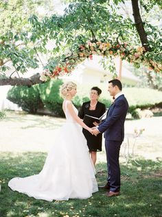 a couple getting married under an apple tree