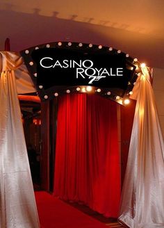 the entrance to casino royale is decorated with red and white drapes, draped curtains, and lights