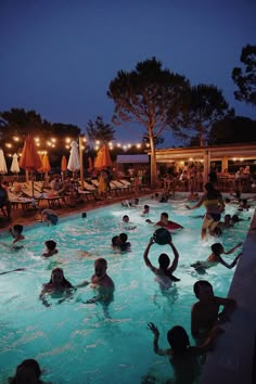 many people are in the swimming pool at night