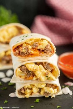 three burritos stacked on top of each other with meat and cheese in the middle