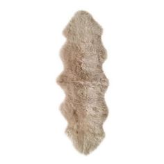 an animal fur rug is shown on a white background, with the bottom part of it's tail visible