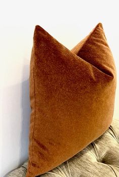 a brown pillow sitting on top of a couch