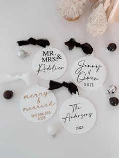 three personalized wedding ornament on top of a white table with other decorations