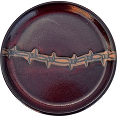 a brown plate with barbed wire on it