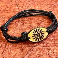 This beautiful Cherokee Nation bracelet is a unique piece of jewelry that embodies the spirit of the tribe. Crafted engraved wood pendant it is a stunning piece that is perfect for any occasion. The slip cord design adds a touch of rustic to the bracelet, making it a must-have for any jewelry collection. The bracelet is perfect for those who love nature, regional, and tribal jewelry, and it is sure to be a conversation starter wherever you go. Cherokee Symbols, Adjustable Cord Bracelet, Cherokee Indian, Engraved Pendant, Indian Crafts, The Tribe, Cord Bracelet, Wood Pendant, Love Nature