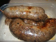 two sausages in a plastic container on a table