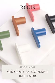 four different colored wooden handles on top of a white board with the words shop now mid century modern bar knobs