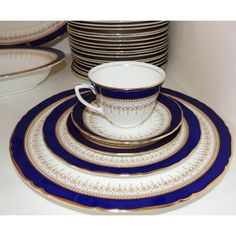 a stack of blue and white plates sitting on top of a table next to each other