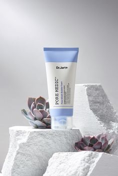 a tube of dr jarett's power effect cream next to a succulent plant