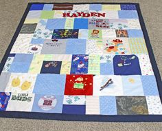 a blue and white quilt on the floor that says,'hadden'with lots of different pictures