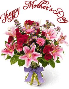 a vase filled with pink and red flowers on top of a white table next to a happy mother's day sign