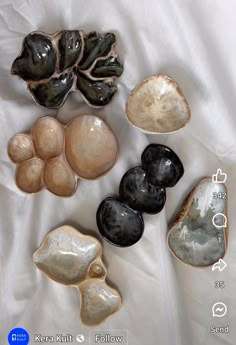 several different types of bowls and spoons on a white sheet