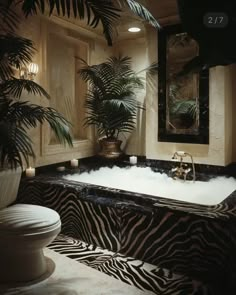 a zebra print bathtub in the middle of a bathroom with palm trees on the wall