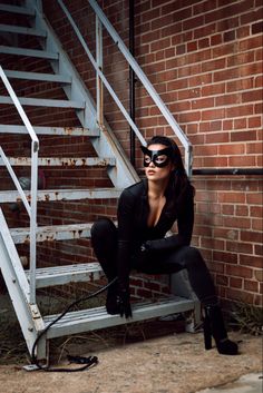 a woman sitting on top of a metal step