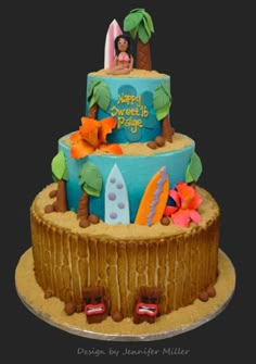 a three tiered cake decorated with surf scenes