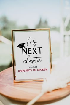 a sign that says my next charter sits on a wooden table in front of a window