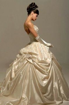 a woman in a wedding dress is looking down at her hand on her hip and the back of her head