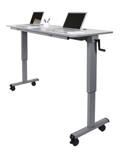 two laptops sitting on top of a desk with wheels attached to the table legs