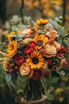 a bouquet of sunflowers, roses and other flowers