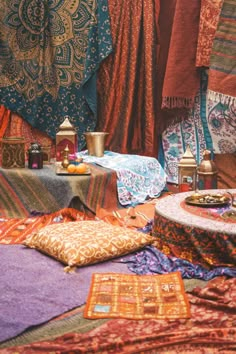 an assortment of colorful fabrics and rugs on display