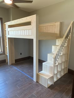 an empty room with stairs leading up to a loft bed in the middle of it