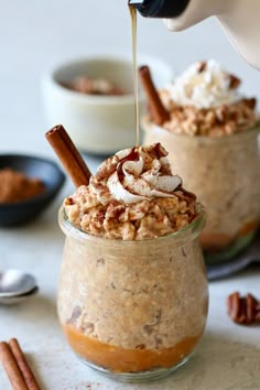 two small jars filled with food on top of a table