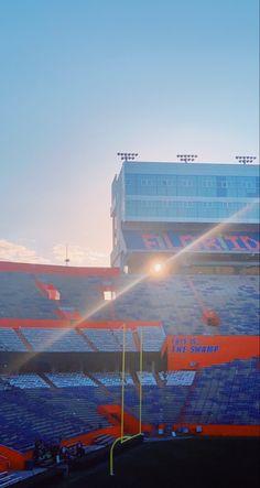 the sun shines brightly on an empty stadium