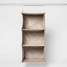 an empty shelf hanging on a white wall