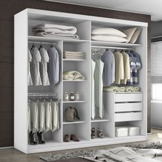 a white closet with clothes and shoes on it's shelves next to a window