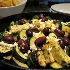 a pan filled with lots of food on top of a table