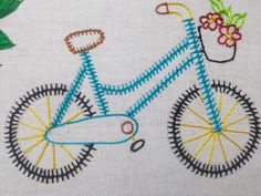 a close up of a cross stitched bike