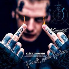 a man holding two fingers up in front of his face, with the words cutie karma on it