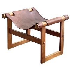 a wooden bench with leather straps on it