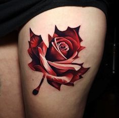 a woman's thigh with a rose tattoo on it