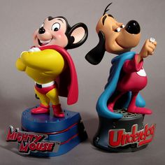 two mickey mouse figurines standing on top of each other