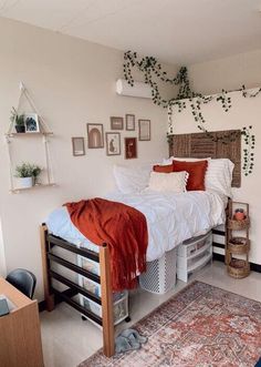 a bedroom with a bed, rug and pictures on the wall above it is shown