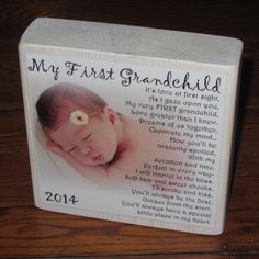 a baby's first grandchild photo block with the words, and an image of a sleeping child