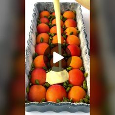 an image of oranges being poured into a container