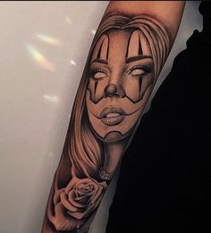 a woman's arm with a face painted on it